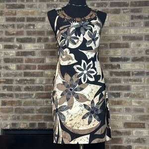 The dress features a mix of black, tan, and white colors